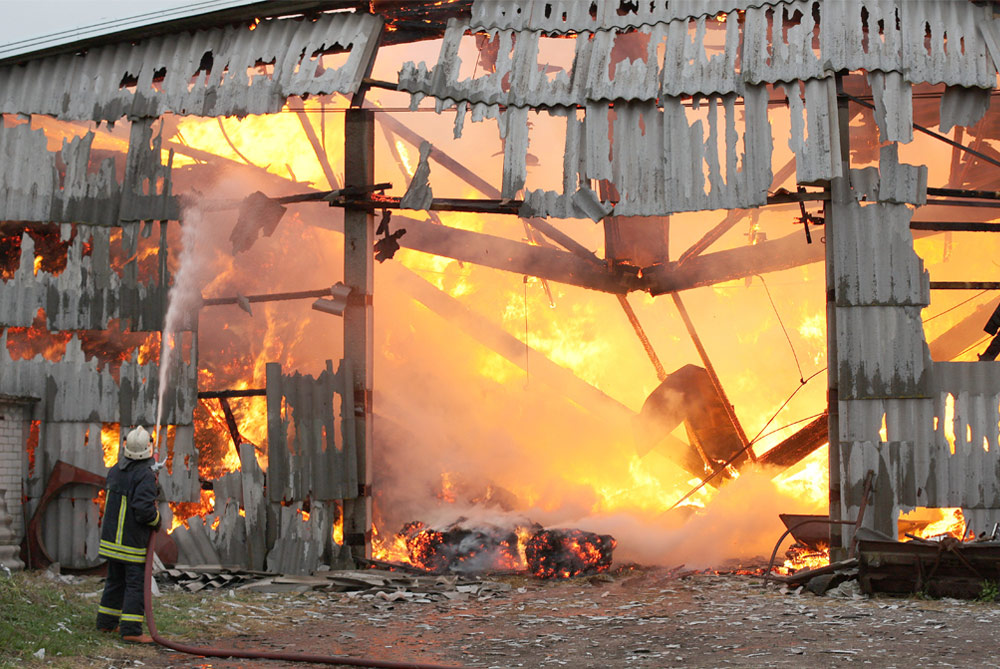Firefighter putting out barn fire